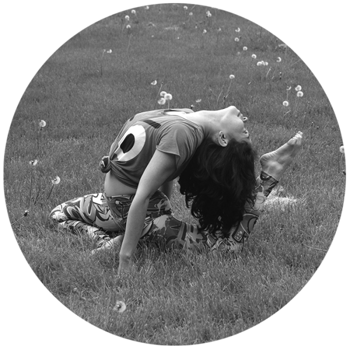 black and white portrait young woman yoga pose pigeon flexibility grassy meadow flowers