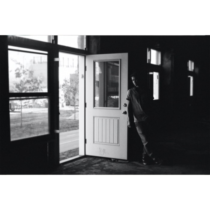 abandoned urbex black and white portrait young man leaning door